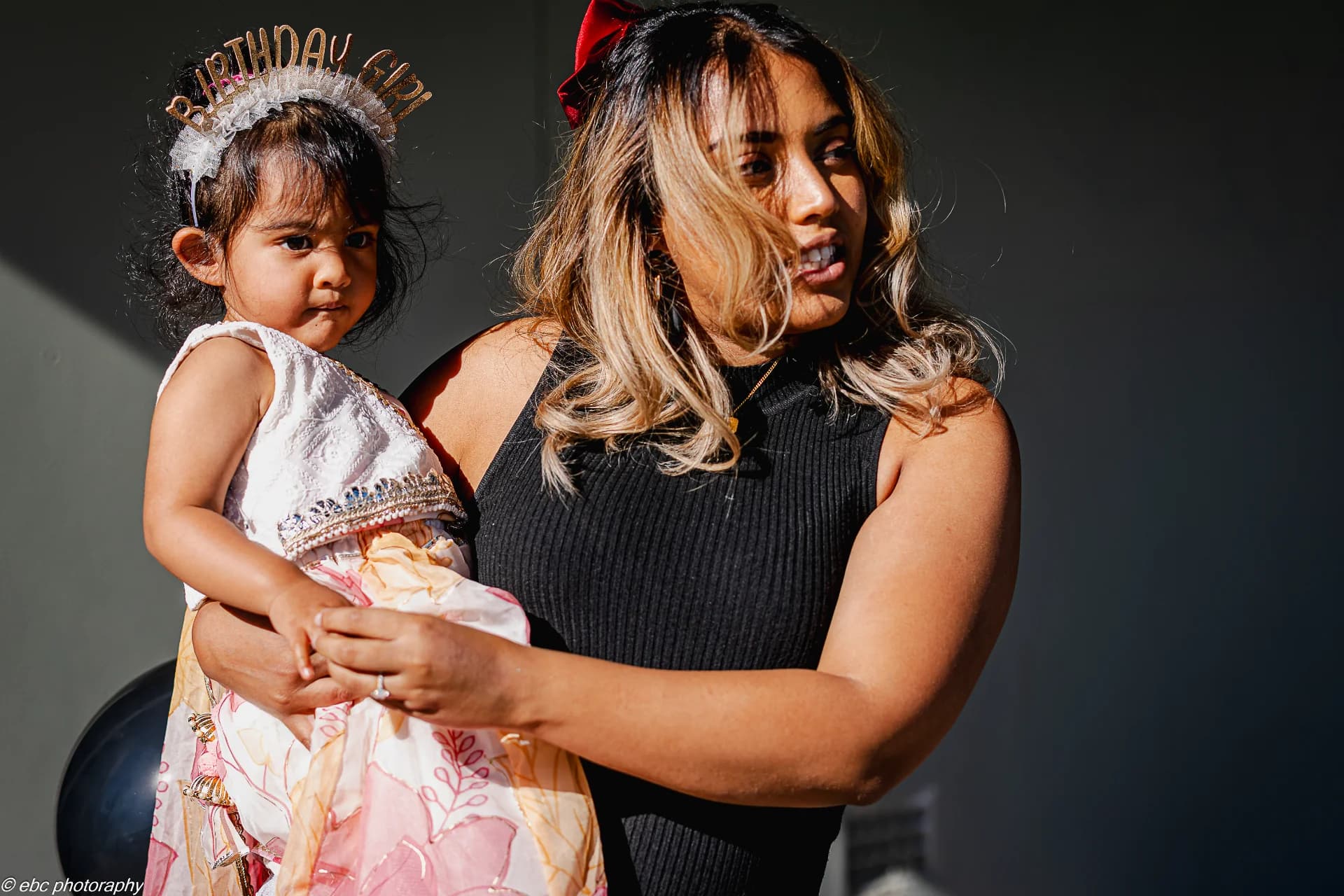 A young girl caretaking of her sister